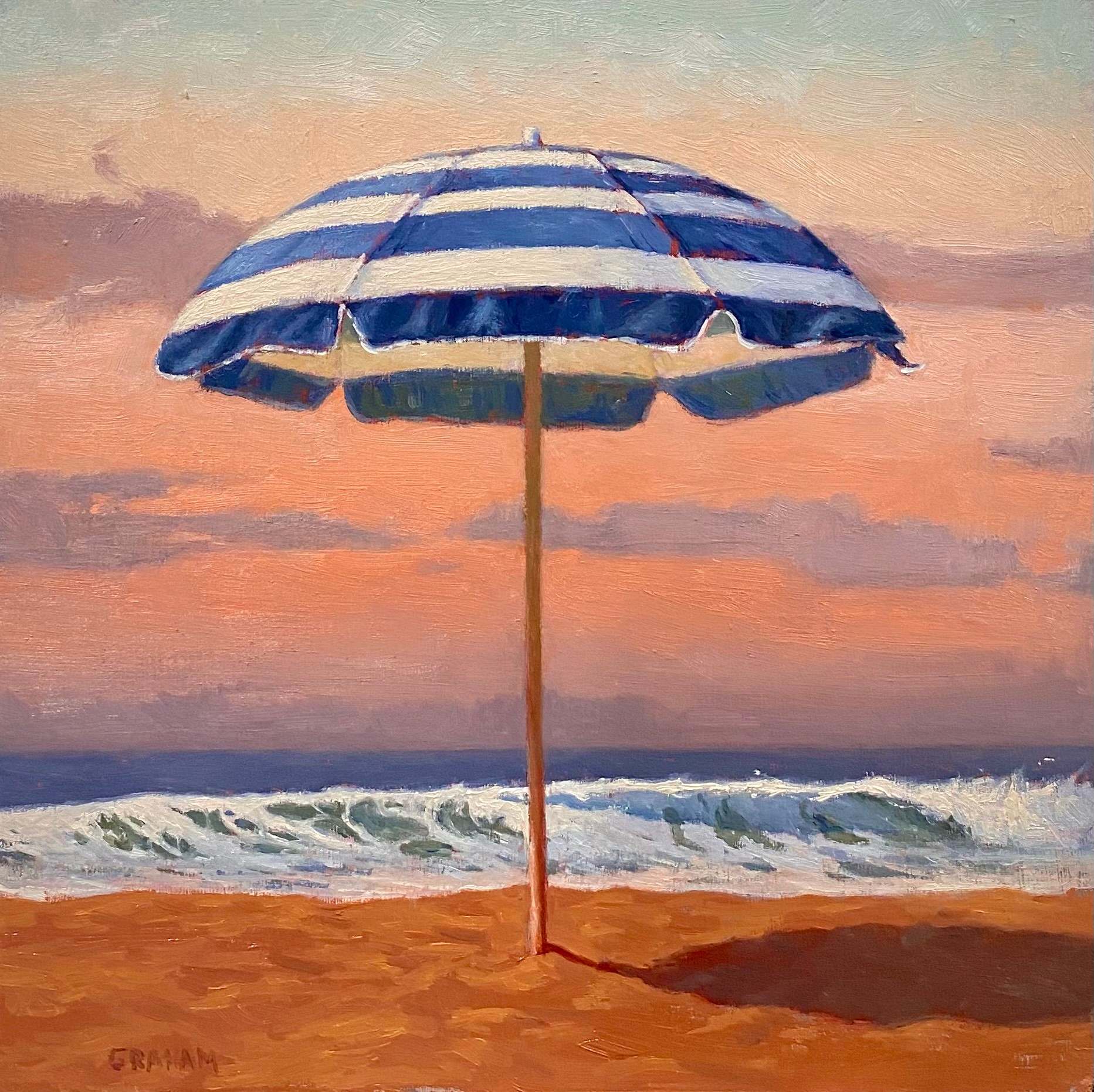 Beach scene with a blue and white striped umbrella on sand, ocean waves, and a colorful sky at sunset.