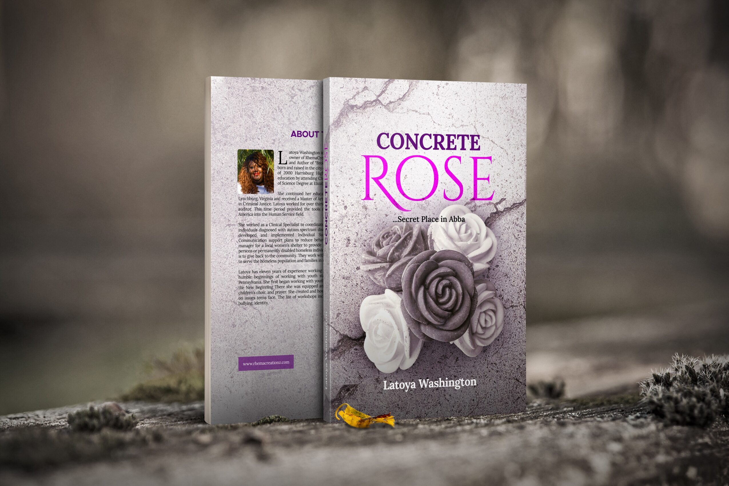 Book titled 'Concrete Rose' with a rose illustration on the cover, standing outdoors on a rough surface.