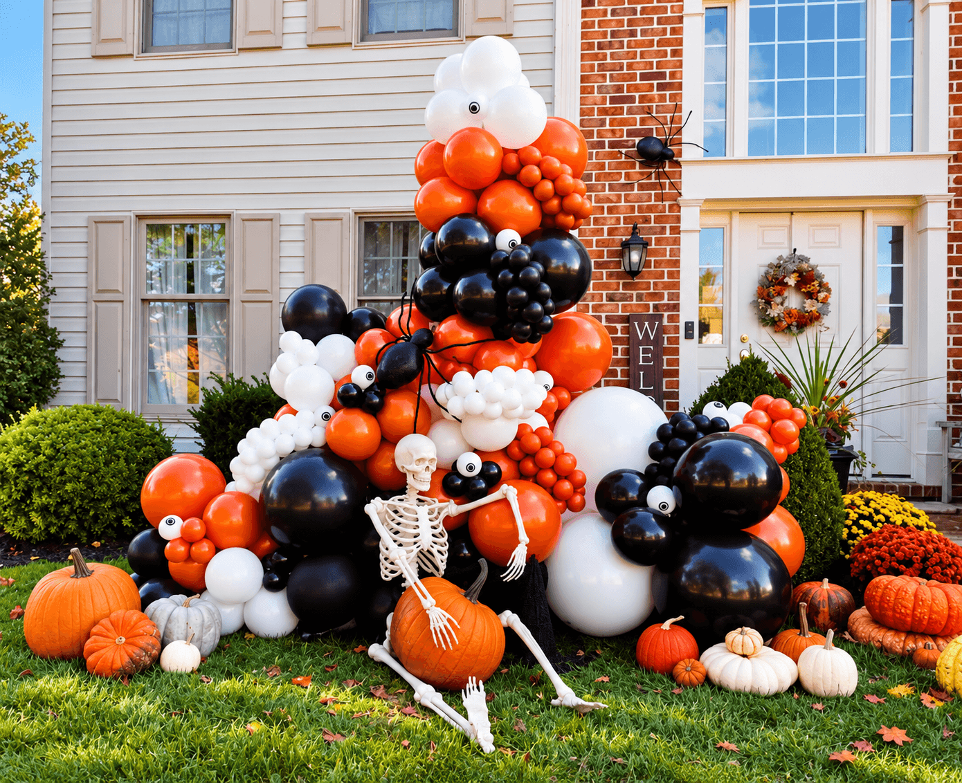 Halloween decoration with balloons, pumpkins, and a skeleton in front of a house, autumn setting, fall colors, and wreath on door.
